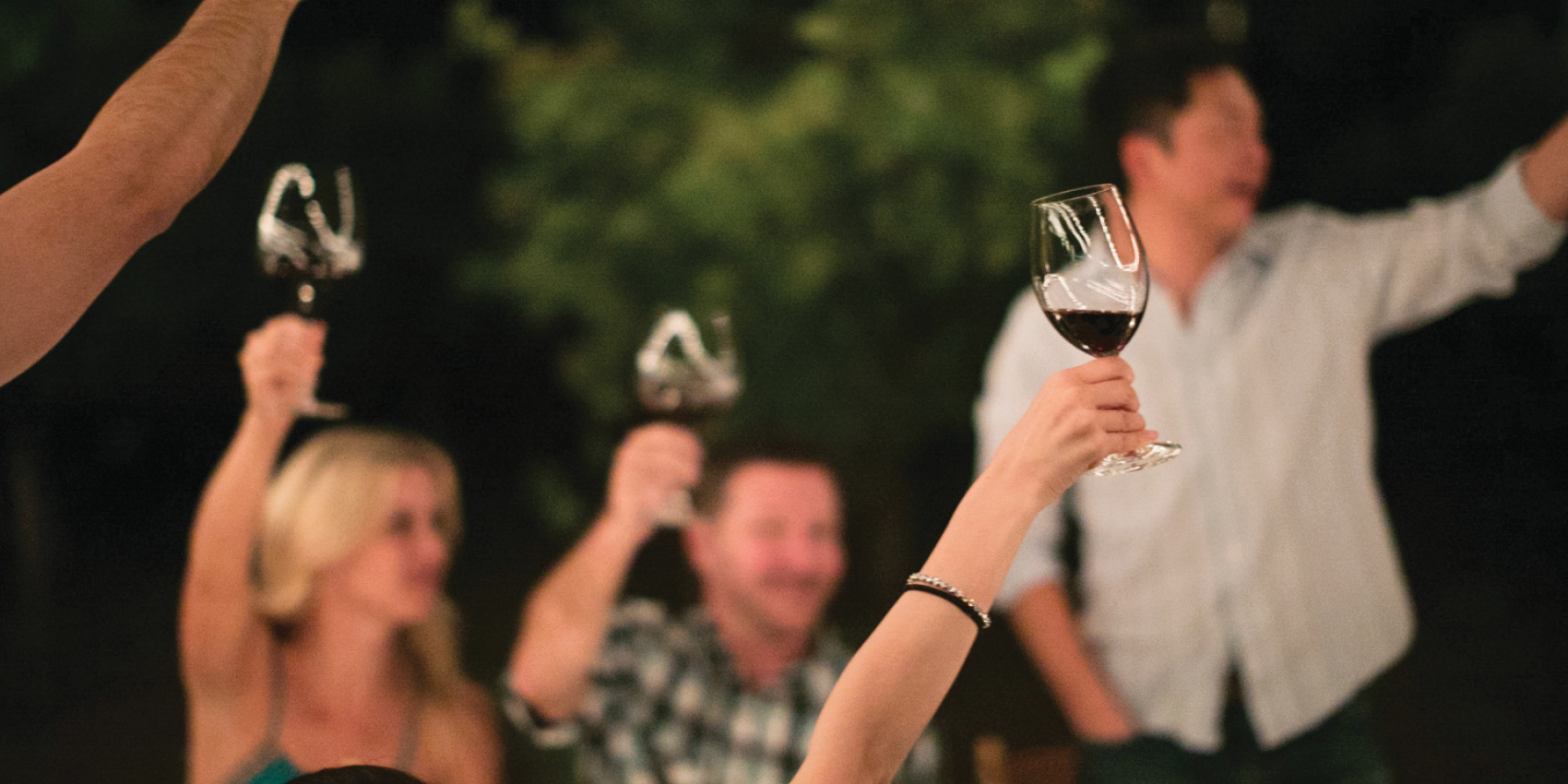 Members of Turnbull Wine Cellars' Membership toasting at an event.